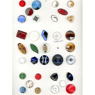 A CARD OF ASSORTED COLORED GLASS DECO BUTTONS