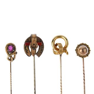 A selection of four stickpins. To include one designed as a horseshoe with buckle detail through its