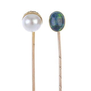 Four stickpins. The first with an oval-shape head set with an opal cabochon, the second a cultured p