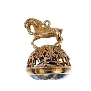 A 9ct gold smoky quartz fob. The circular smoky quartz, to the pedestal designed as a horse with rei
