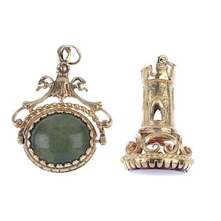 Two 9ct gold fobs. The first designed as a castellated turret with an oval-shape claw-set carnelian,