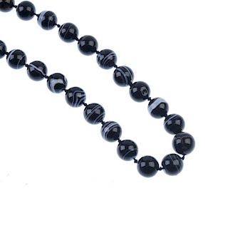 An agate bead necklace. Comprising of thirty spherical agate beads, to the partially concealed push-