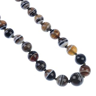 An agate bead necklace. Comprising a series of twenty-nine graduated spherical agate beads, to the s