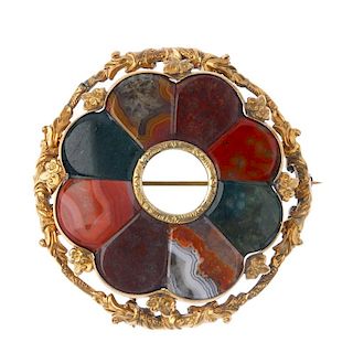 A late 19th century Scottish brooch. Designed as a scalloped-edge central panel of vari-coloured aga
