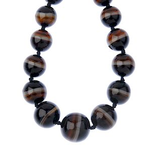 An agate bead necklace. Comprising a series of twenty-three graduated spherical beads, to the spring