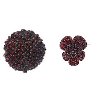 Two late 19th century garnet and paste brooches. To include a circular-shape red paste and garnet fl