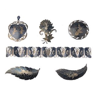 A selection of silver and white metal Siam jewellery. To include a brooch shaped as a feather depict