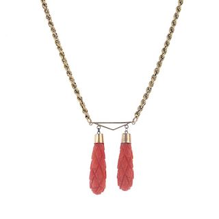 A coral necklace. Designed as a rope chain with four spherical coral beads at irregular intervals, t