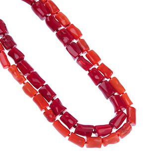 Two treated coral necklaces and two pairs of matching earrings. Both designed as cylindrical treated
