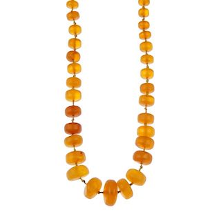 A natural amber necklace. The forty-five graduated natural amber beads measuring 8 to 20mm, to the s