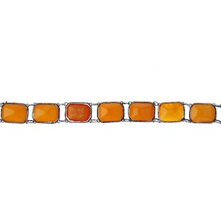 An amber bracelet. Each of the eight links designed as a rectangular amber piece, collet-set to a ro