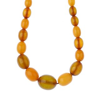 A natural amber bead necklace. Comprising thirty-four graduated oval-shape beads measuring 2 to 0.8c