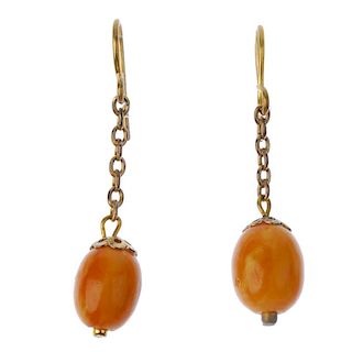 A selection of amber pieces. To include a pair of natural amber ear pendants, the oval beads to the