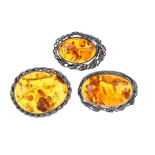 A selection of modified amber silver and white metal set jewellery. To include three amber pendants