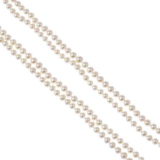 Two long cultured pearl necklaces. Both designed as long-length single rows of white pearls. 	Length