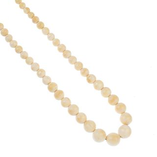 An early 20th century ivory bead necklace. Comprising ninety-six graduated spherical ivory beads mea