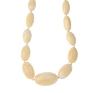 An early 20th century ivory bead necklace. Comprising fifty-six graduated oval beads measuring 1.3 t