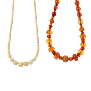 A faceted natural amber bead necklace and an early 20th century ivory bead necklace. The ivory neckl