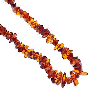 A reformed amber piece necklace and a branch coral necklace. The necklace comprising a series of gra