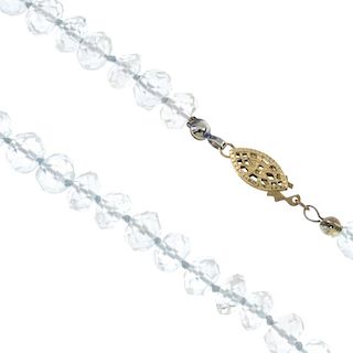 An aquamarine bead single-strand necklace. The faceted aquamarine beads, measuring 7mms, to the open
