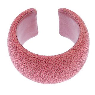 A pink stingray cuff. The salmon pink stingray cuff with pink leather lining signed Maximos. Inner d