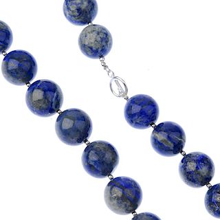 A lapis lazuli bead necklace and ear pendants. The necklace comprising eleven spherical beads measur