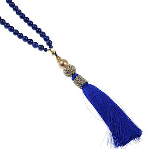 A treated lapis lazuli necklace and ear pendants. The necklace designed as a series of spherical bea