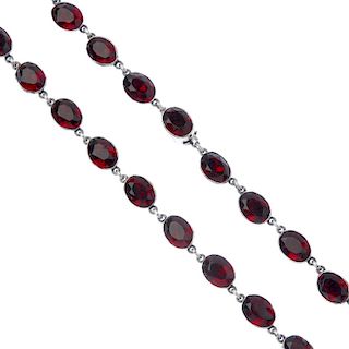 A paste necklace. Designed as a series of oval-shape red paste collets, to the similarly-designed pa
