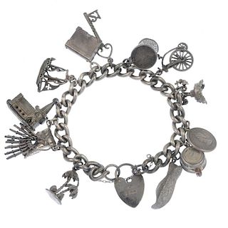 Three charm bracelets. The two curb-link chains and fancy-link chain suspending thirty-nine charms t