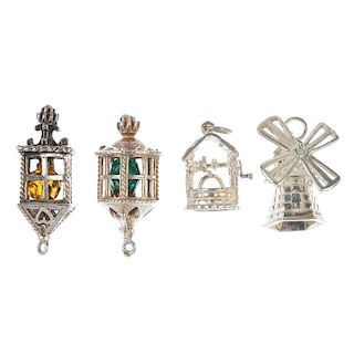 A selection of sixty-nine assorted charms. Sixty-nine charms to include a windmill charm with revolv
