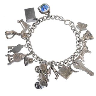 Two charm bracelets. Both of curb-link chain design, suspending a total of thirty-one charms, to inc