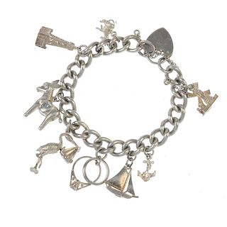 Two charm bracelets. The two curb-link chains suspending a total of fifteen charms including a boot