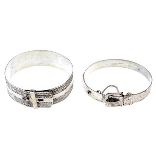 A selection of silver and white metal bangles. To include a scroll engraved cuff, a 1950s silver scr