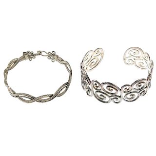 A selection of silver and white metal bangles. To include a square profile bangle, a hinged silver b