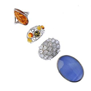 A selection of rings and charms. The thirty-six rings including one with a dyed oval-shape shell inl