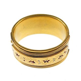 A gold plated split pearl and red paste hinged bangle. The half-bangle with rope-twist detail to the