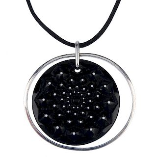 LALIQUE - a 'Cactus' pendant. The black and white accent glass disc, with impressed floral motif, su