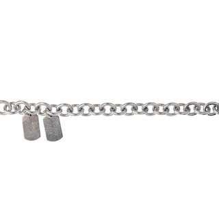 GUCCI - a silver bracelet. The belcher-link bracelet suspending two 'Gucci' engraved dog tags, each
