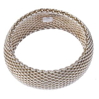 TIFFANY & CO. - a silver bangle. Of wide mesh design. Signed Tiffany & Co. Hallmarks rubbed. Inner d
