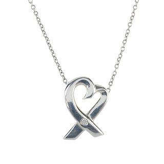 TIFFANY & CO. - a diamond set pendant. The fine-link chain suspending a heart shape crossing over to