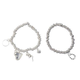 Five items of silver designer jewellery. To include two 'Sweetie' charm bracelets and a plain band r