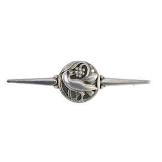 GEORG JENSEN - a brooch. Designed as a bar brooch, the bar tapering to each end, to the central circ