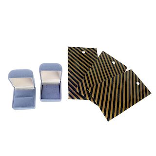 Seventy-six boxes and 200 small bags. To include grey flocked ring boxes and gold and black striped