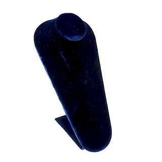 A box containing display props. The blue velvet display props include a bust, drop earring stands, a