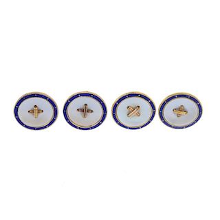 A part-set of four early 20th century 15ct gold mother-of-pearl and enamel buttons. Each designed as