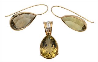 14 Karat Gold Three-Piece Set, to include earrings and pendant with teardrop stones and small diamonds in pendant, total weight 9.1 grams.