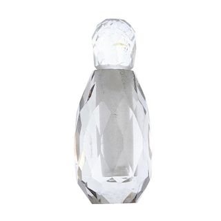 A faceted rock crystal perfume bottle. The rock crystal bottle, cut into an oval-shape with the lid,