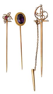 Three 14 Karat Gold Stick Pins, to include one fly with four diamonds, ruby, and one pearl; along with sword having diamonds, pearls, and one amethyst