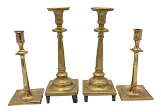 Two Pairs of Early Brass Candlesticks, having square bases on footed base, heights 9 1/2 and 12 inches.
