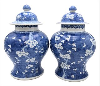 Pair of Chinese Blue and White Covered Temple Jars, 19th century, baluster shape, decorated with white prunus flowers and branches on blue ground, hei